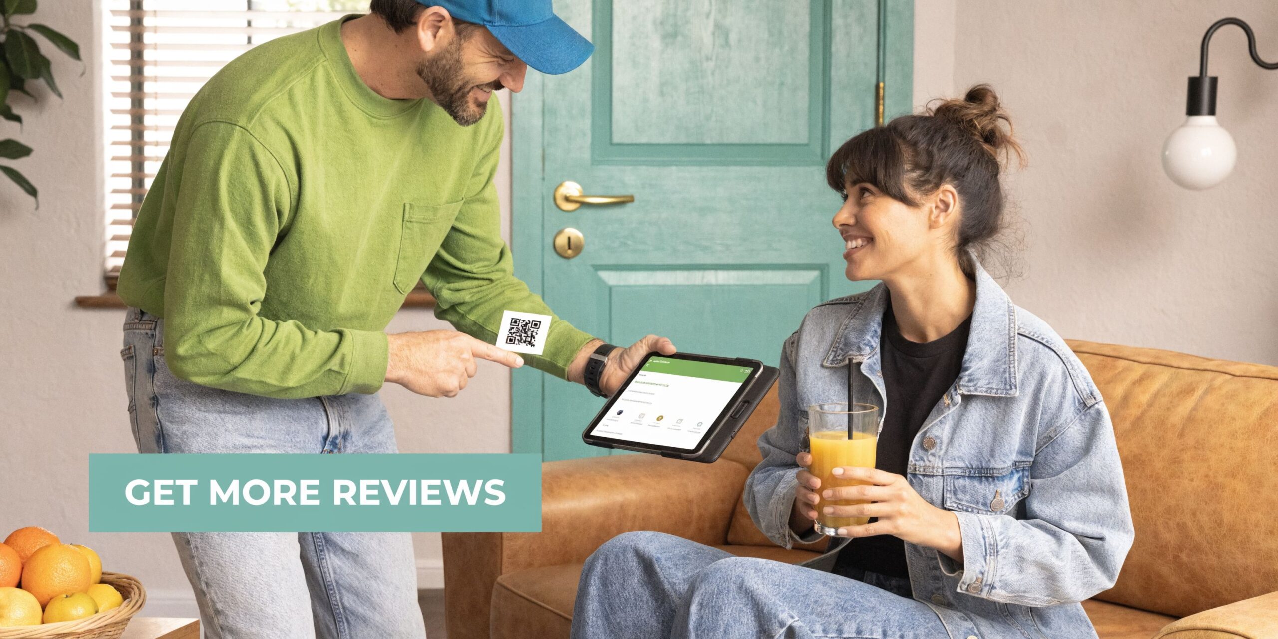 A delivery man presenting a QR code and tablet to a woman holding a glass of juice.